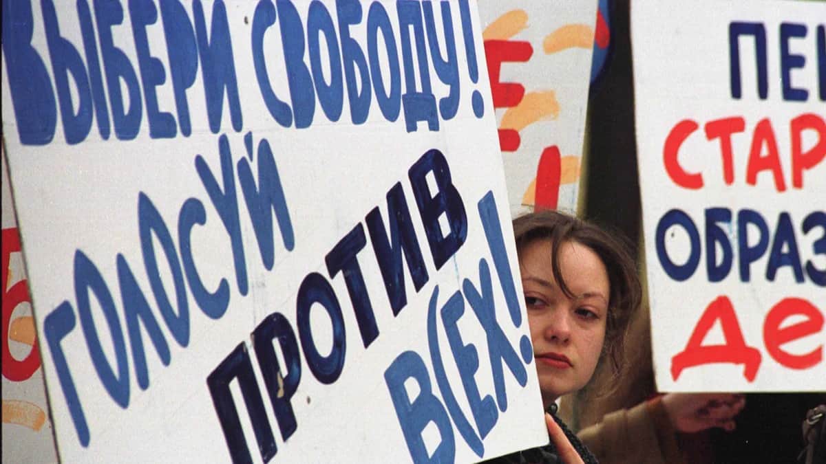 Участница пикета на Тверской площади в центре Москвы держит плакат с лозунгом «Выбираем свободу! Голосуем против всех», 18 марта 2000 года. Фото: Олег Никишин / Newsmakers / Vida Press